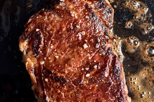 Indulge in Strip Steaks with Mushrooms, Bacon, & Blue Cheese